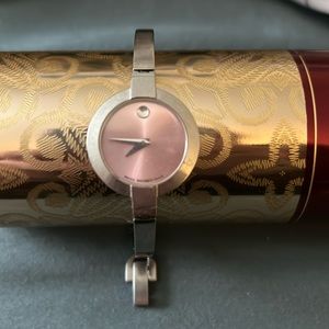 Silver Movado watch with light pink face